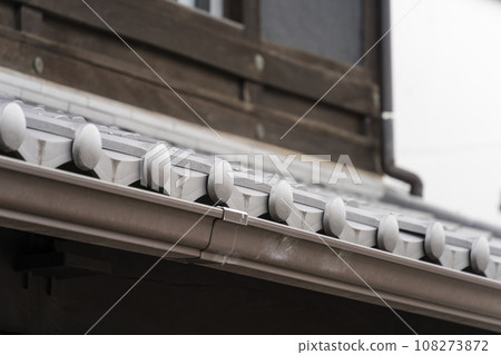 Old house tiles and rain gutters Old house tiles and rain gutters 108273872