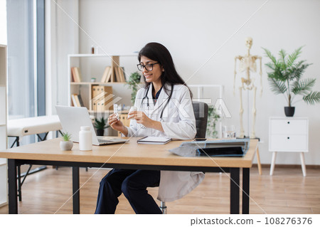 Nurse having conversation with patient on video call indoor Nurse having conversation with patient on video call indoor 108276376