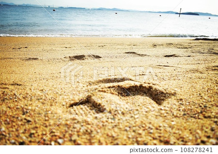 Footprints remaining on the beach 108278241