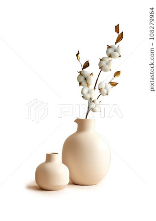 Modern beige ceramic vases with dry cotton branches. Neutral trendy colors interior decoration . Modern beige ceramic vases with dry cotton branches. Neutral trendy colors interior decoration . 108279964