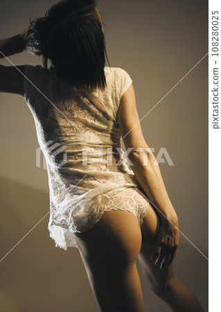 Sensuous lingerie model posing in studio 108280025
