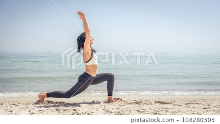 Fitness Girl working out on the beach 108280303