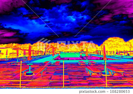 Dark clouds above hot beach with parasols and chairs Dark clouds above hot beach with parasols and chairs 108280653