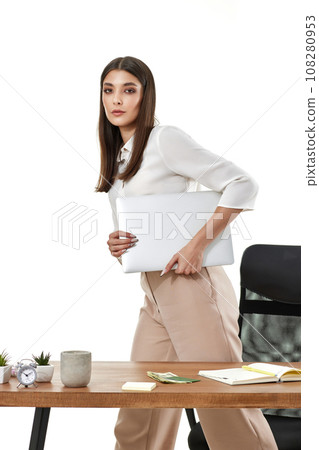 Young beautiful woman holding laptop computer. Businesswoman working in office. 108280953