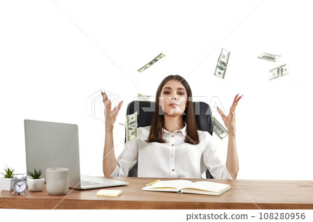 businesswoman working on laptop and throwing money while sitting on chair at desk. banknotes fly in the air 108280956