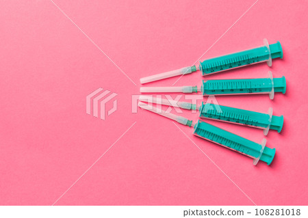 Top view of medical syringes on colorful background with copy space. Injection equipment concept 108281018