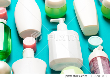 Top view of different cosmetic bottles and container for cosmetics on colored background. Flat lay composition with copy space Top view of different cosmetic bottles and container for cosmetics on colored background. Flat lay composition with copy space 108281092