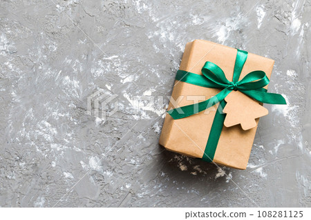 wrapped christmas or other holiday handmade present in paper with colored ribbon. Present box, decoration of gift on colourfull table, top view with copy space wrapped christmas or other holiday handmade present in paper with colored ribbon. Present box, decoration of gift on colourfull table, top view with copy space 108281125