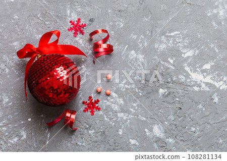 Christmas ball on colored background. decoration bauble with ribbon bow with copy space Christmas ball on colored background. decoration bauble with ribbon bow with copy space 108281134