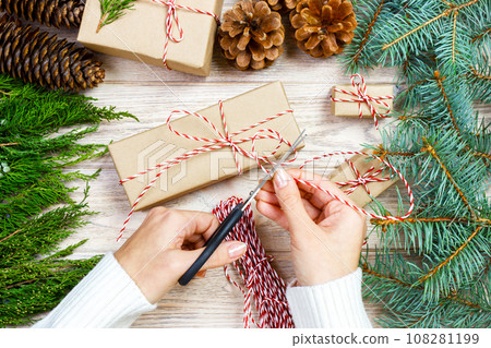 Woman wrapping presents for Christmas. Gift wrapping 108281199