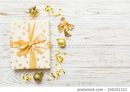 Top view Flat lay Christmas decorations and gift box on colored background with copy space. Christmas or Happy New Year composition Top view Flat lay Christmas decorations and gift box on colored background with copy space. Christmas or Happy New Year composition 108281322