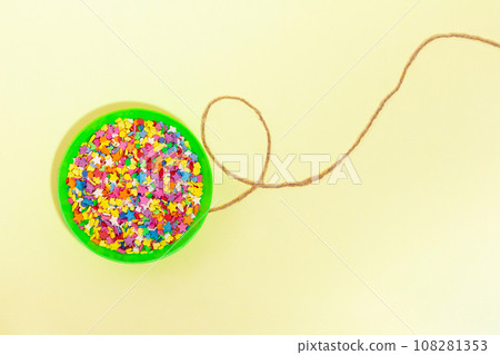 Balloon with sweets confetti on a string. Copy space 108281353