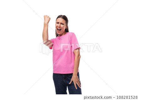 young positive good-looking woman with black hair dressed in a pink t-shirt rejoices in winning 108281528