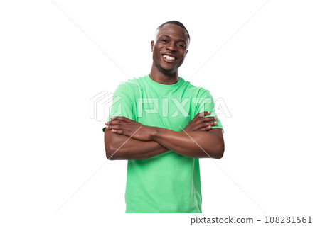 young leader african man dressed in green t-shirt and jeans looks confident young leader african man dressed in green t-shirt and jeans looks confident 108281561