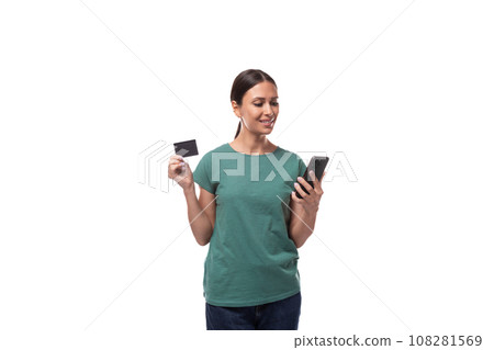 young brunette woman in t-shirt holding credit card and smartphone young brunette woman in t-shirt holding credit card and smartphone 108281569