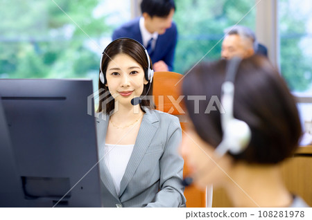 Female operator working at a call center Female operator working at a call center 108281978