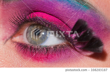 Crop of female eye with colorful make up. Beautiful fashion model with creative art makeup. Crop of female eye with colorful make up. Beautiful fashion model with creative art makeup. 108283187