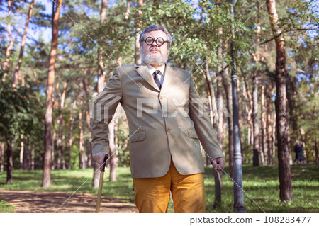 Funny old man with a stick. 108283477