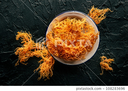 Irish sea moss on a black slate background, healthy organic food supplement 108283696