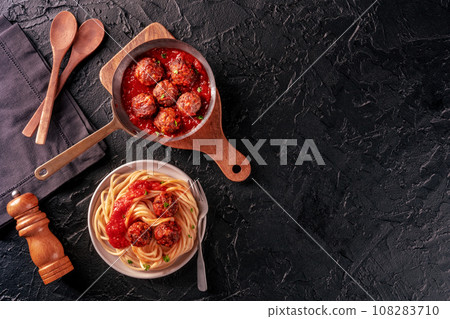 Meatballs. Beef meat balls, overhead flat lay shot in a pan and with spaghetti Meatballs. Beef meat balls, overhead flat lay shot in a pan and with spaghetti 108283710