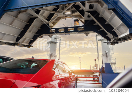 Front open door of passenger freight cargo ferry boat vessel ship with loaded cars and vehicles. Sea transportation ferryboat transport carrier unloading disembark. Northern Europe sea line 108284004