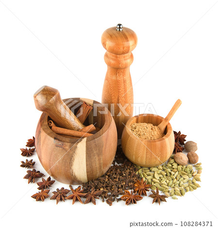 Mortar with pestle, hand mill and spices set isolated on white. Mortar with pestle, hand mill and spices set isolated on white. 108284371