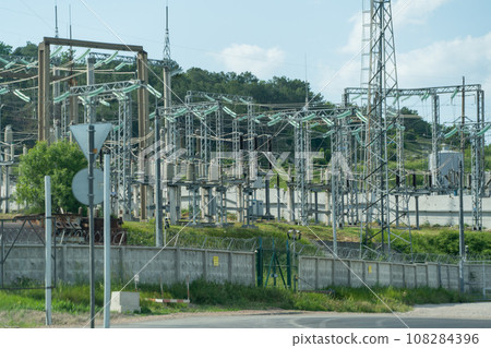 High voltage towers with sky background. Power line support with wires for electricity transmission. High voltage grid tower with wire cable at distribution station. Energy industry, energy saving 108284396