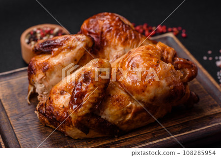 Crispy delicious whole baked chicken with vegetables, salt and spices Crispy delicious whole baked chicken with vegetables, salt and spices 108285954