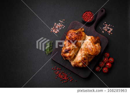 Crispy delicious whole baked chicken with vegetables, salt and spices 108285963