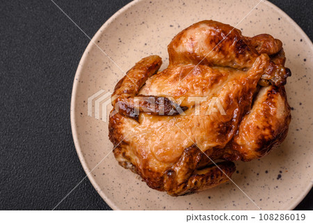 Crispy delicious whole baked chicken with vegetables, salt and spices 108286019