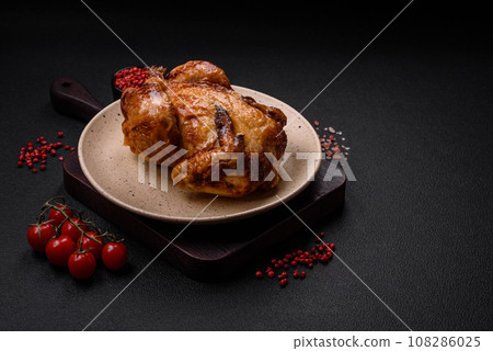 Crispy delicious whole baked chicken with vegetables, salt and spices 108286025