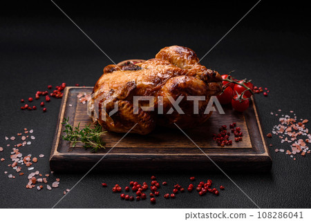 Crispy delicious whole baked chicken with vegetables, salt and spices 108286041