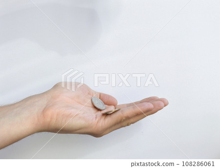 Russian coins on an open palm on a white background. there are coins in the hand Russian coins on an open palm on a white background. there are coins in the hand 108286061