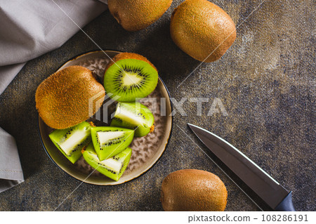 Fresh ripe sliced kiwi fruit on a plate on the table top view Fresh ripe sliced kiwi fruit on a plate on the table top view 108286191
