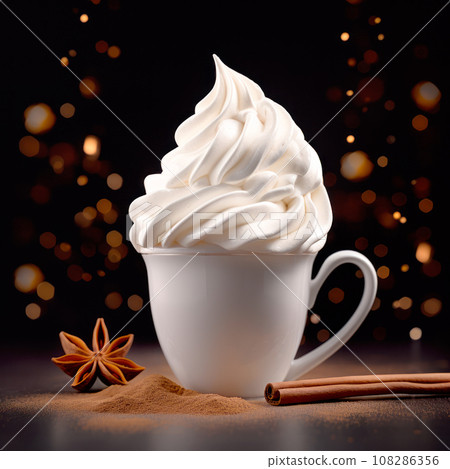 A white coffee with whipped cream in ceramic cup sitting on a black table and bokeh backdrop. Autumn and Winter mood. A white coffee with whipped cream in ceramic cup sitting on a black table and bokeh backdrop. Autumn and Winter mood. 108286356