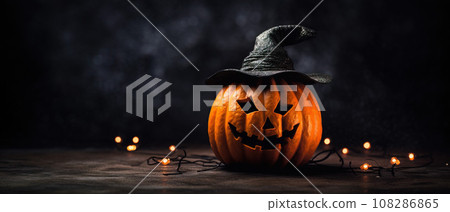 Carved out glowing orange halloween pumpkin jack o lantern on black background with copy space Carved out glowing orange halloween pumpkin jack o lantern on black background with copy space 108286865