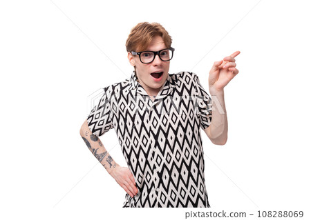 a young emotional man with red hair and a tattoo on his arms is dressed in a short-sleeved shirt a young emotional man with red hair and a tattoo on his arms is dressed in a short-sleeved shirt 108288069