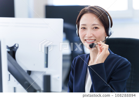 Portrait of a woman working in a call center Portrait of a woman working in a call center 108288894