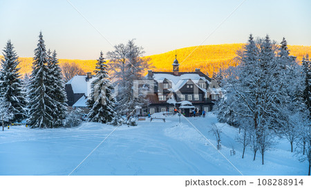 Cross-country skiing on winter evening. Samalova Hut on Nova louka in Jizera Mountains, Czech Republic Cross-country skiing on winter evening. Samalova Hut on Nova louka in Jizera Mountains, Czech Republic 108288914