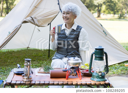 Cute lady enjoying camping 108289205