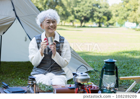 Cute lady enjoying camping 108289209