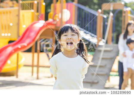 Cute child playing with play equipment 108289690