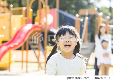 Cute child playing with play equipment 108289695