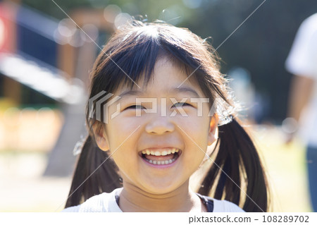 Cute child playing with play equipment 108289702