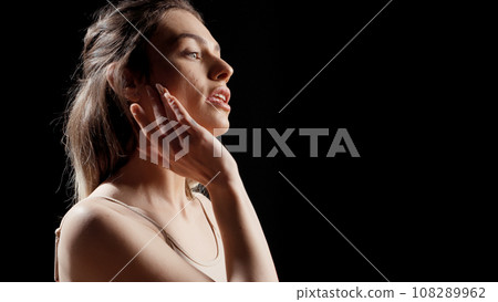 Woman with glamourous style doing beauty campaign and posing on camera for skincare products ad. Young female model acting confident and gentle, being sensual with beauty routine. 108289962