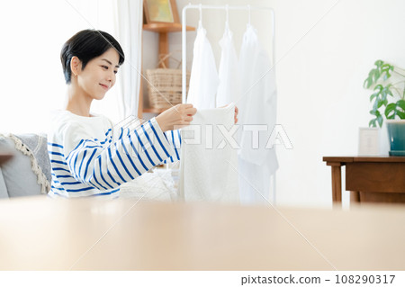 A woman doing housework with a smile A woman doing housework with a smile 108290317