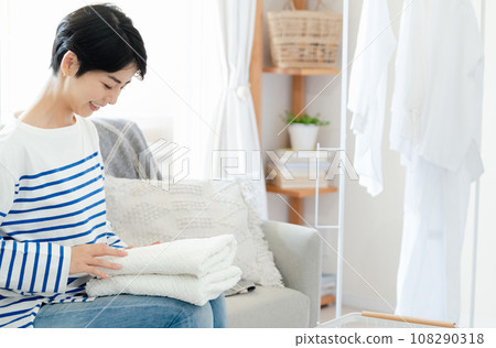 A woman doing housework with a smile A woman doing housework with a smile 108290318