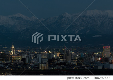 Panoramic compositing with adjacent images possible Winter night view of Toyama city area and Mt. Kuwazaki in the Northern Alps from Kurehayama Observation Deck Panoramic compositing with adjacent images possible Winter night view of Toyama city area and Mt. Kuwazaki in the Northern Alps from Kurehayama Observation Deck 108292658