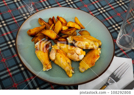 Fried barbecue chicken wings with baked potato Fried barbecue chicken wings with baked potato 108292808