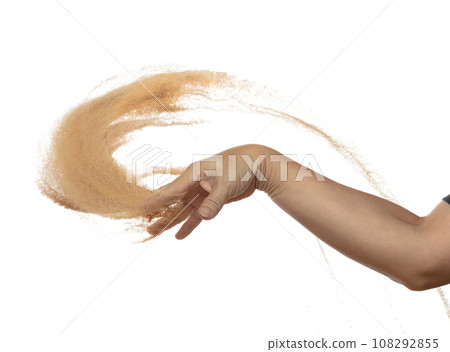 Hand throwing find sand in air. Arm wrist hand throw sand and splash explode through fingers and shape curve circle. Sand freeze stop freeze in Air. White background Isolated 108292855